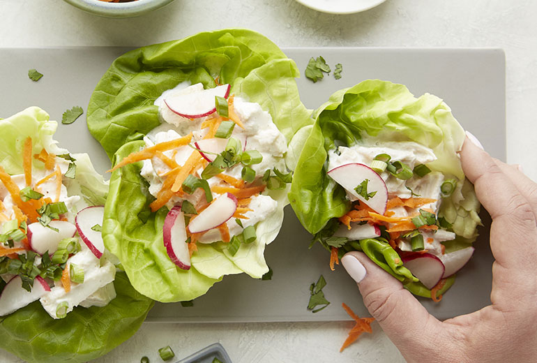 a tray with three lettuce wraps