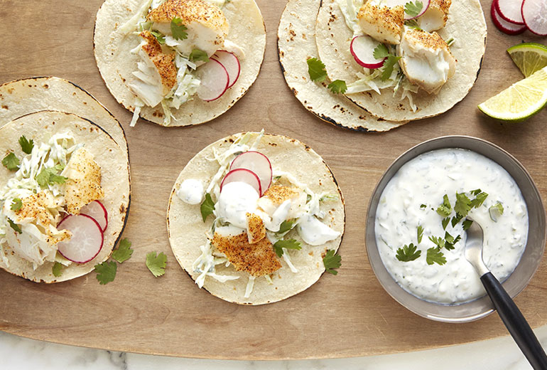 fish tacos on a wood serving platter